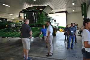 Attendees check out the massive farm equipment at Plattner Farms.